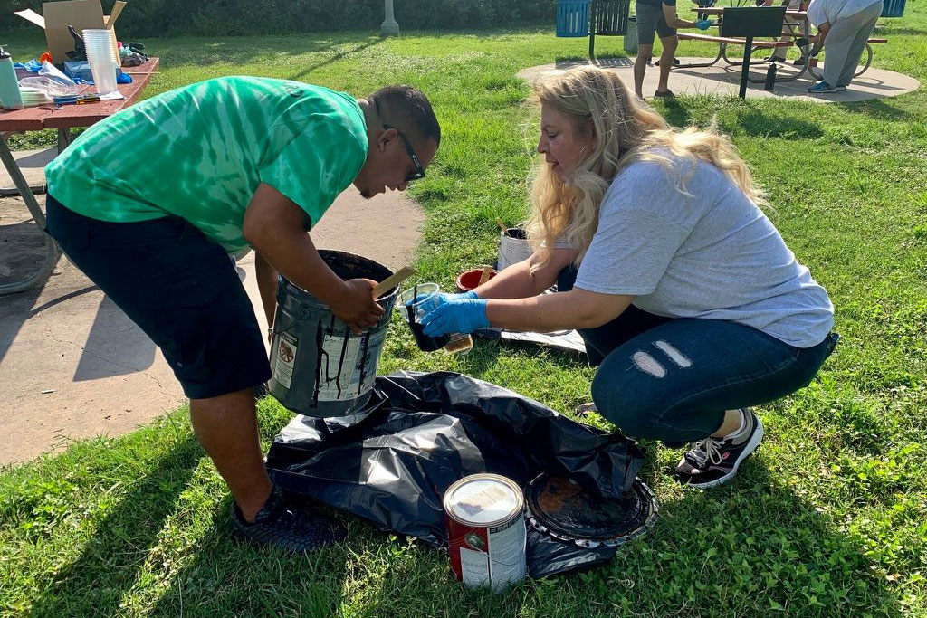 Employees and family members of Culligan of San Antonio clean up Brackenridge Park in San Antonio, TX.